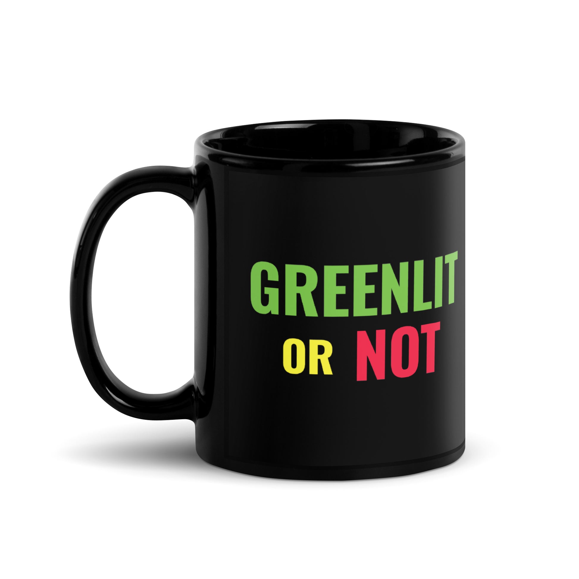 Black 11-ounce glossy ceramic mug featuring the full-color stacked Greenlit or Not™ logo on the left and the neon film reel graphic in green, yellow, and red on the right.